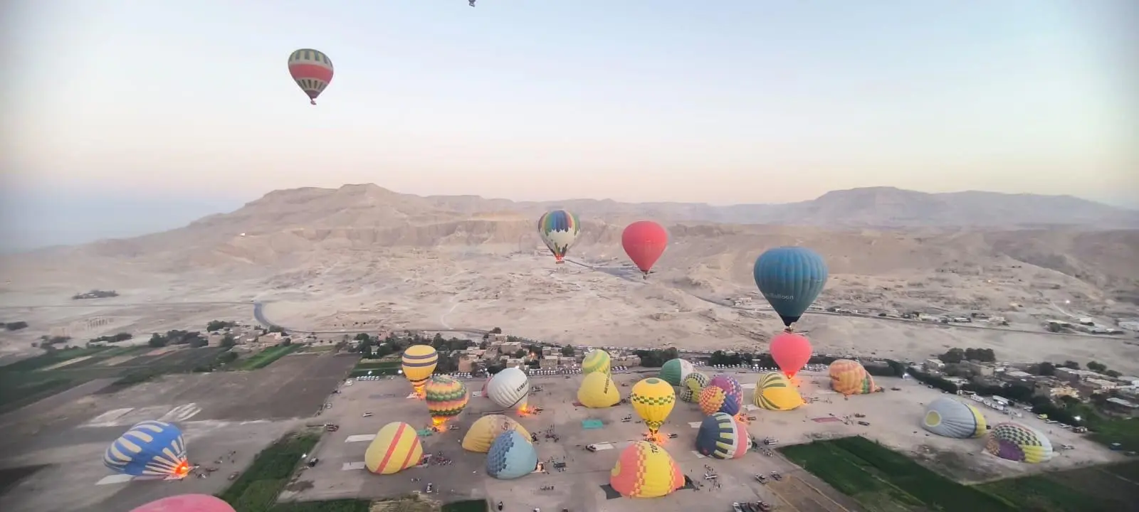 Hot air balloons over the Valley of the Kings at sunrise