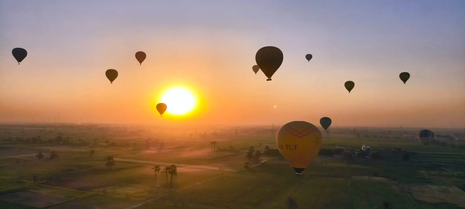 Hot air balloons over the Valley of the Kings at sunrise
